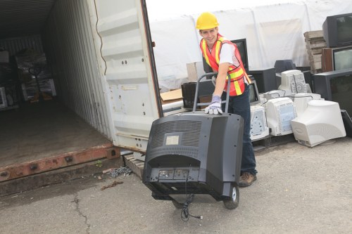 Team member handling hazardous waste with protective equipment